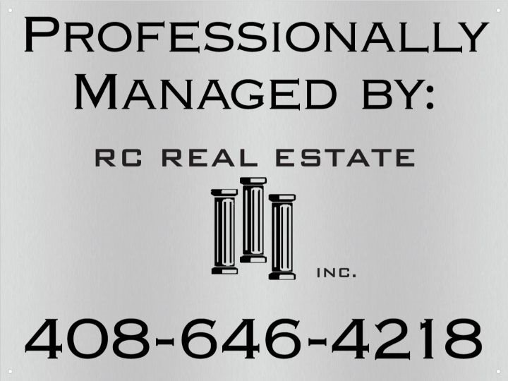 A sign that says "Professionally Managed By: RC Real Estate" with a phone number below it.